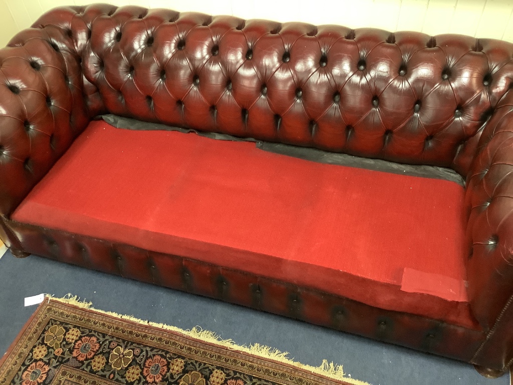 A Victorian style buttoned burgundy leather Chesterfield settee, width 206cm depth 88cm height 70cm